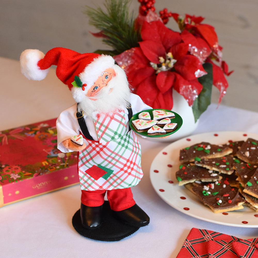 Annalee 9in Christmas Candy Santa in plaid apron and Santa hat holding a plate of Christmas treats