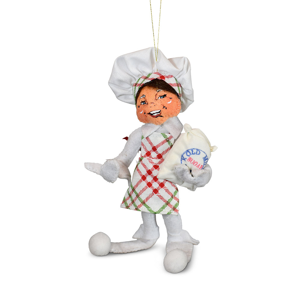 Annalee 5in Christmas Candy Elf ornament in white felt with chef hat and plaid apron holding a bag of sugar