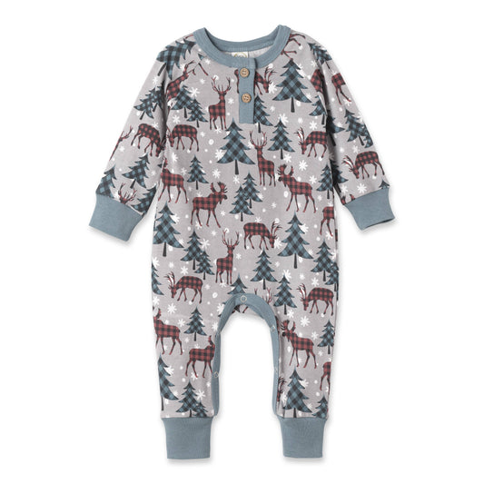 A festive Christmas-themed baby romper with a pattern of trees and reindeer, featuring a blue Henley neckline and cuffs.