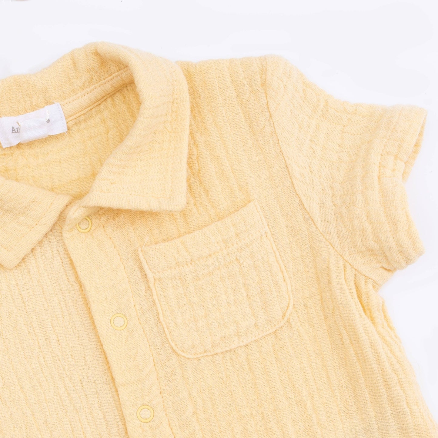 Yellow sleeveless shirt with a collar on a white background