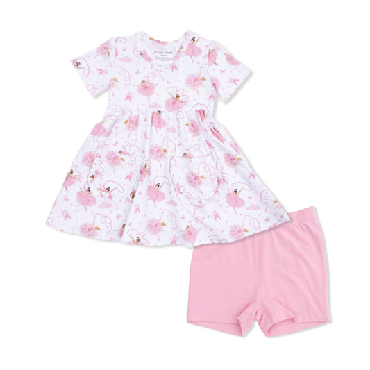 Children's dress with bellerina pattern and pink shorts on a white background
