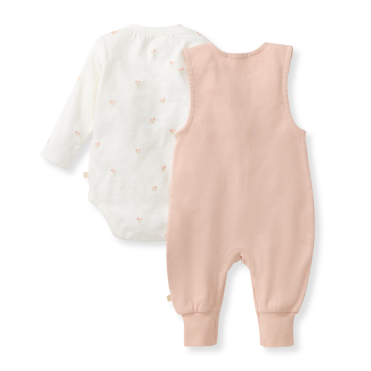 Baby romper with long-sleeve top and pink overalls on a white background