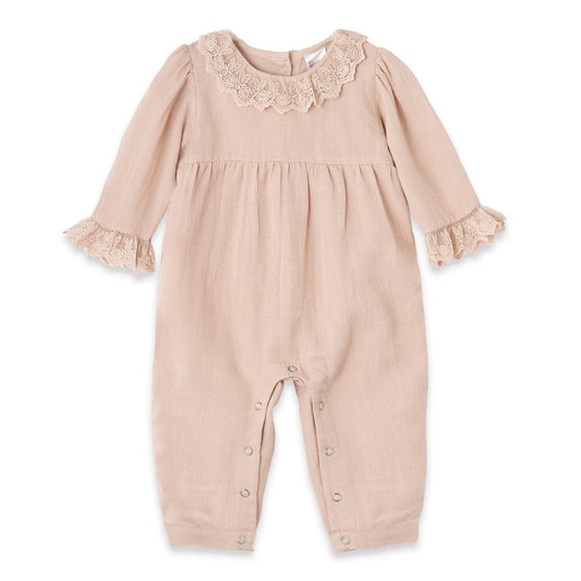 Beige baby romper with lace details on a white background