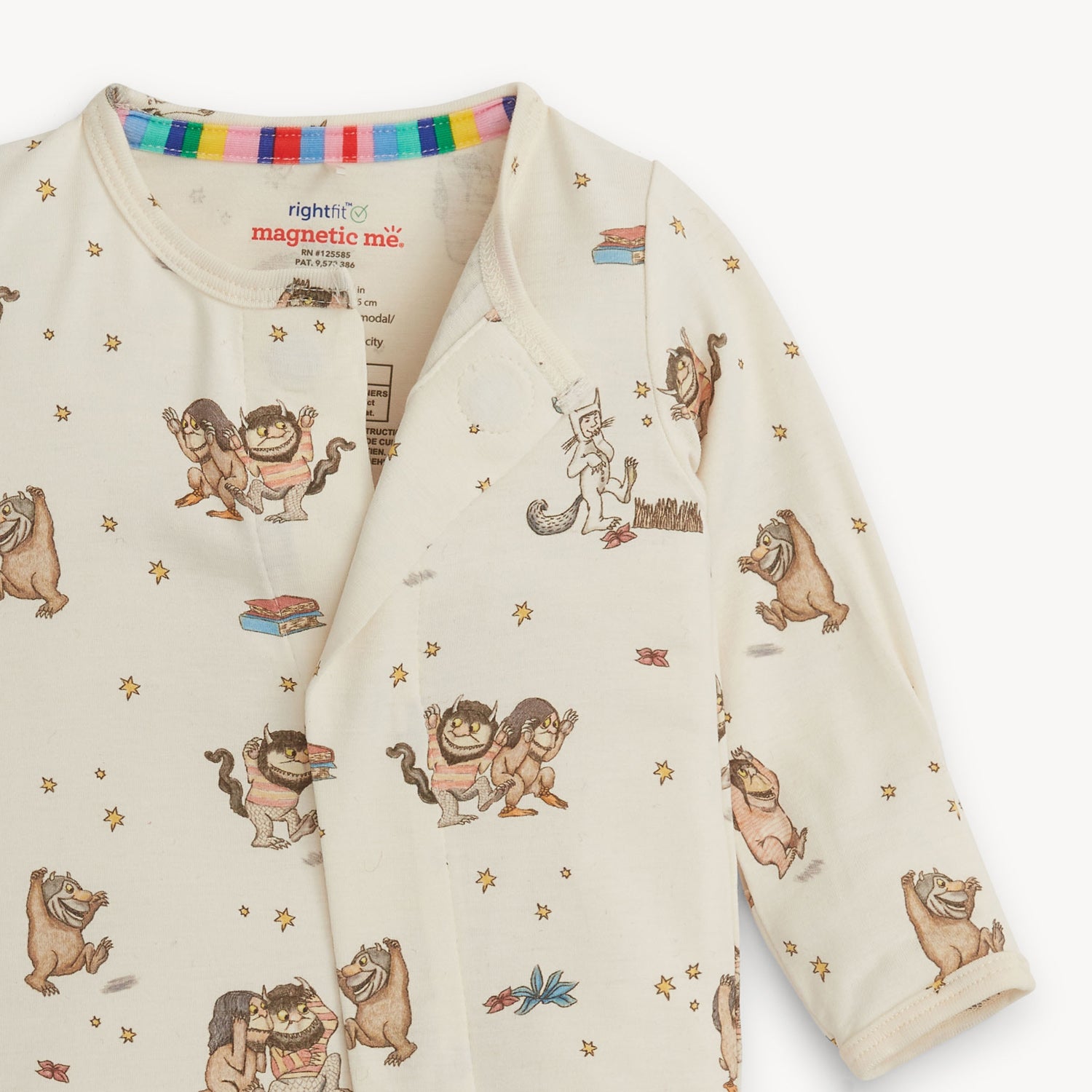 Baby footie with Where the Wild Things Are print showing magnetic closure on a white background