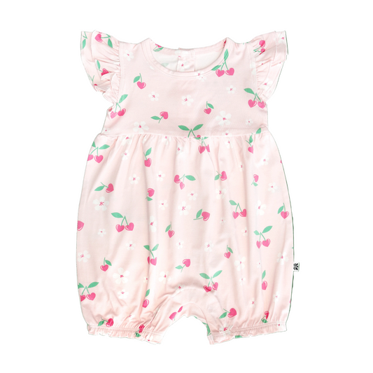 Pink baby romper with cherry pattern on a white background