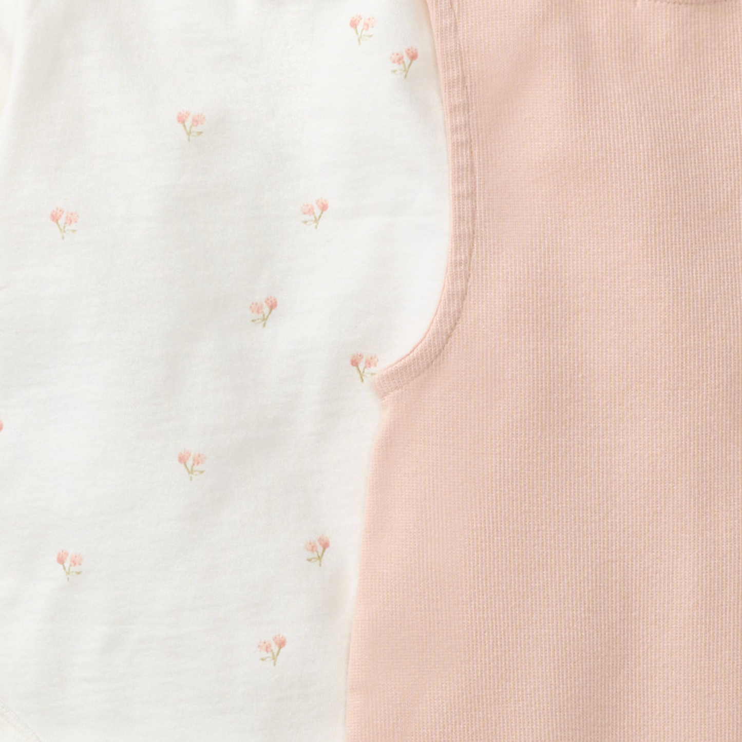 close-up of pink overalls and romper with delicate pink flowers