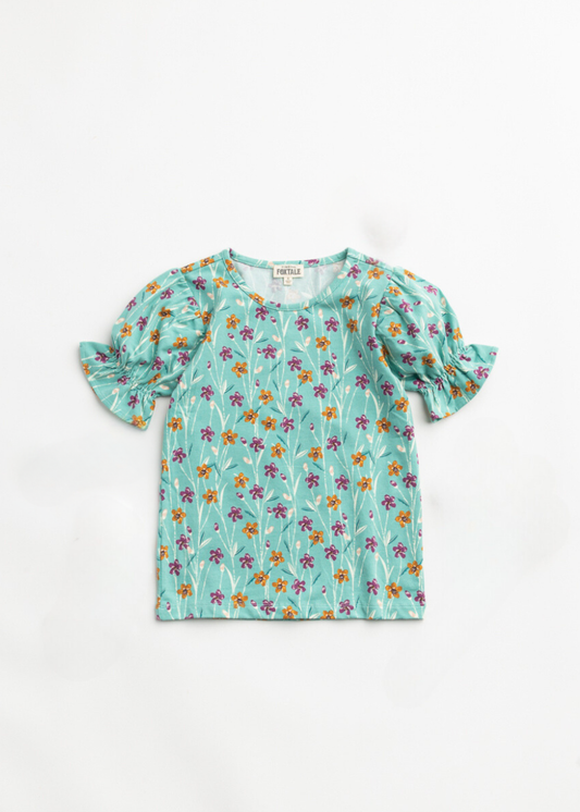 Children's floral blouse with ruffled sleeves on a white background