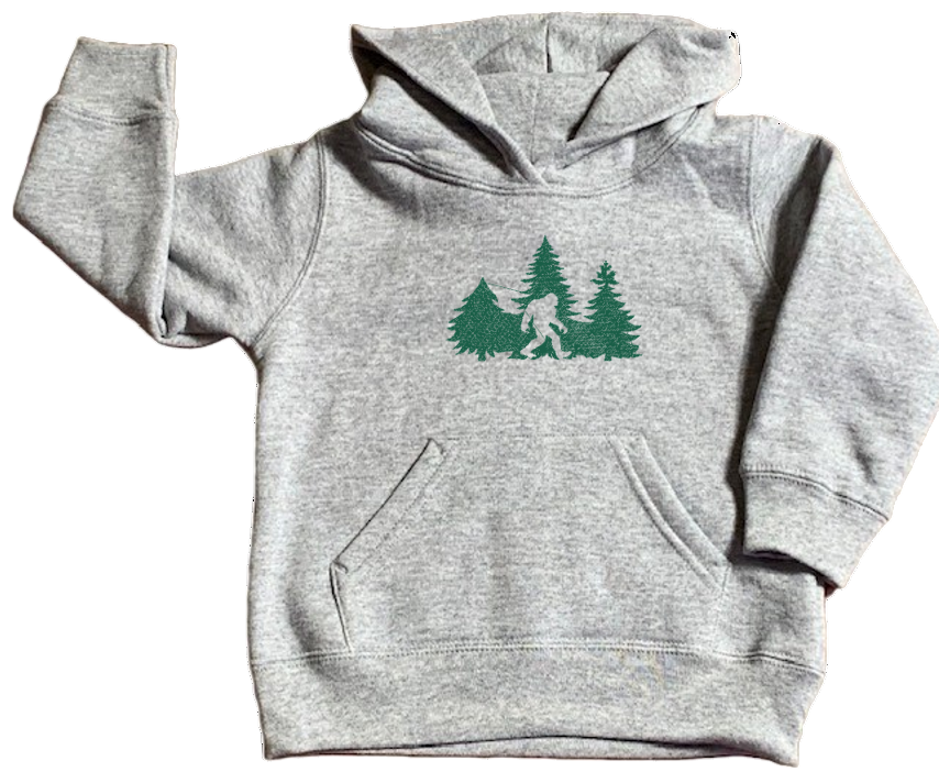 Gray hoodie with green graphic of a forest and bigfoot on a white background