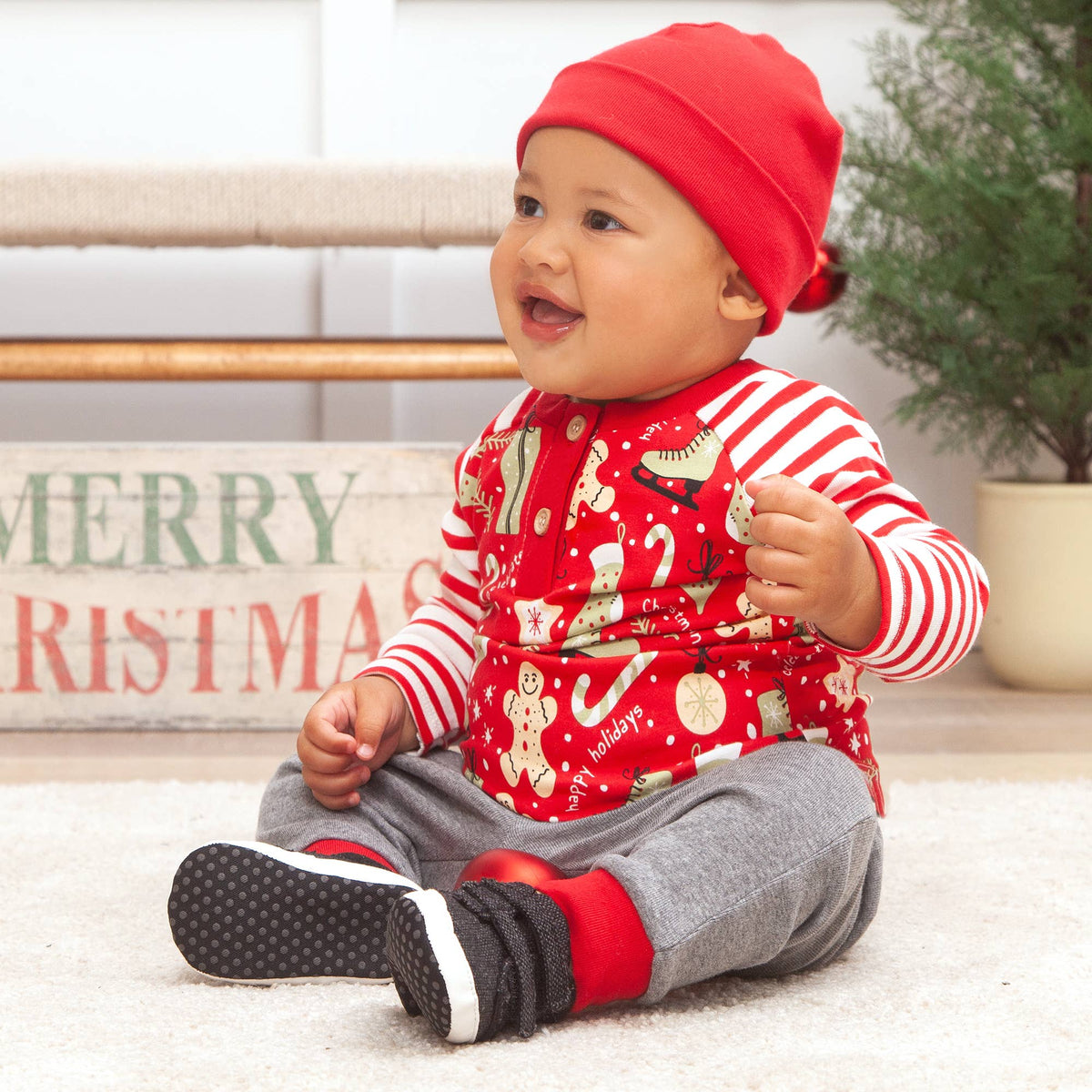 Baby in festive outfit sitting on floor