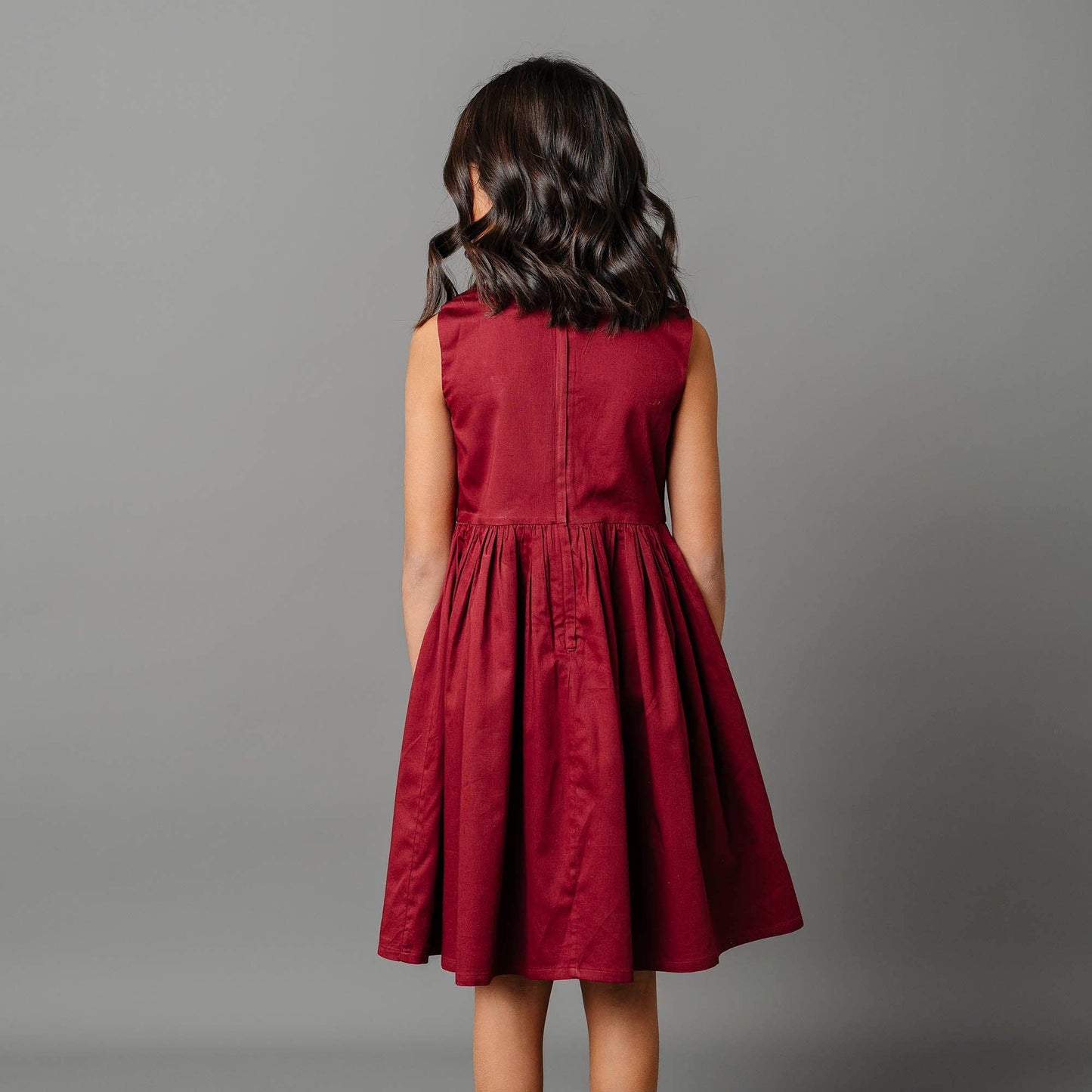 Red dress worn by a person on a gray background