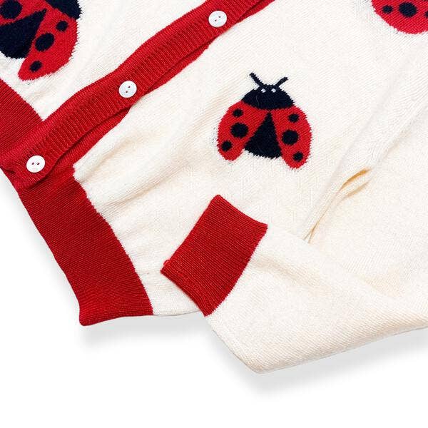 Red and white cardigan with ladybug patterns on a white background