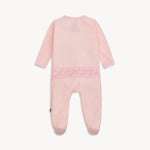 Pink baby onesie with lace details on a white background