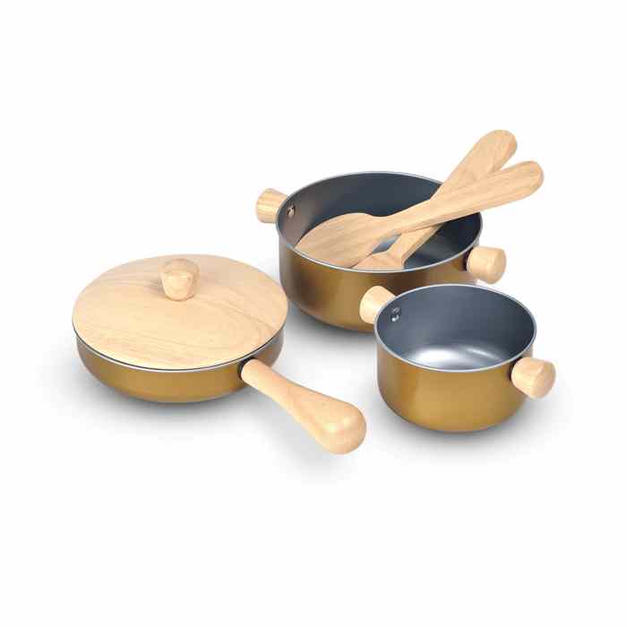 Set of toy cookware with wooden handles on a white background