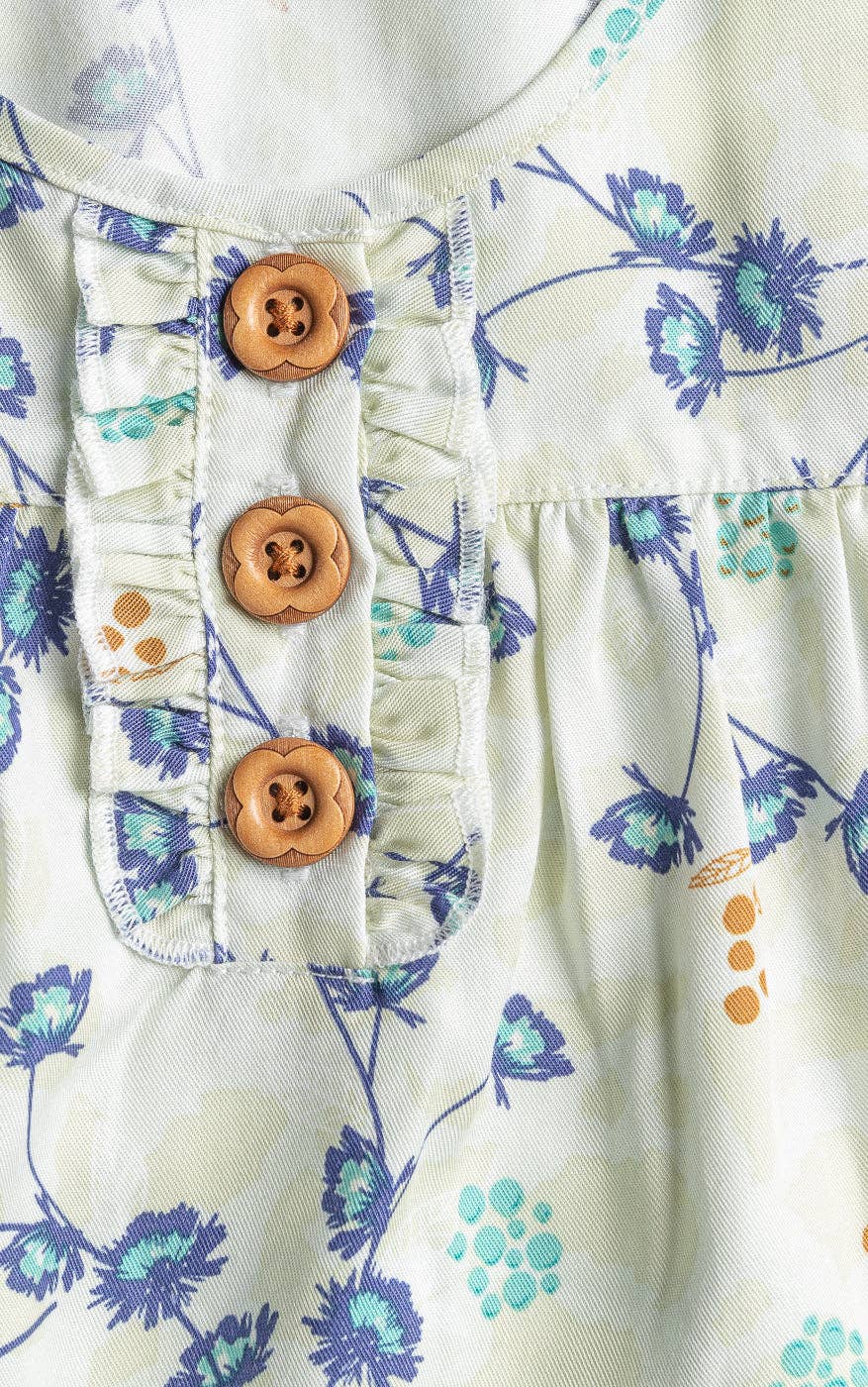 Floral-patterned fabric with wooden buttons on a white background