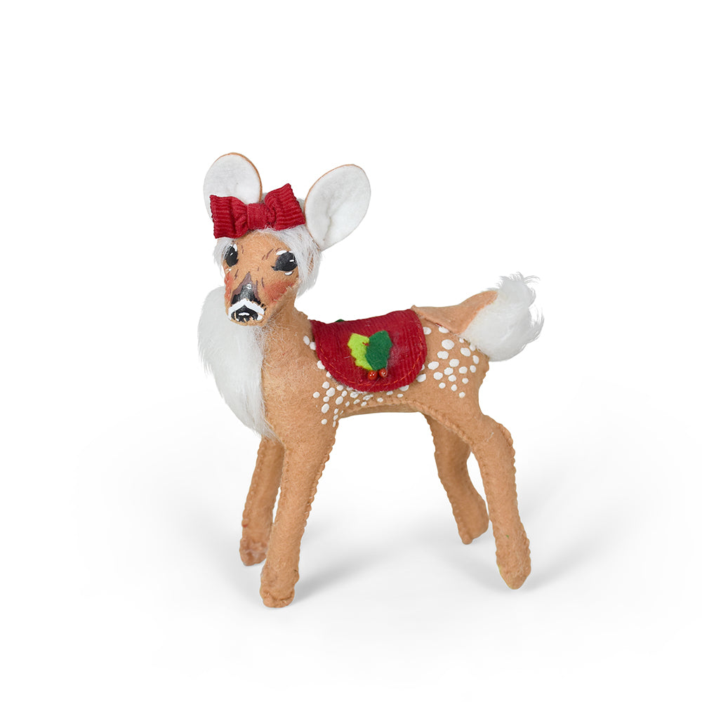 Annalee 5 inch Yuletide Fawn doll wearing a red corduroy blanket with holly and a bow on its head