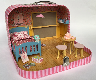 Toy suitcase with a miniature bedroom setup including a bed, table, and chairs.