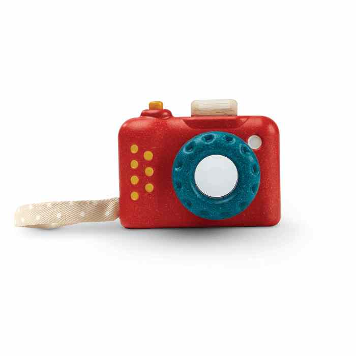 Red toy camera with a blue lens on a white background