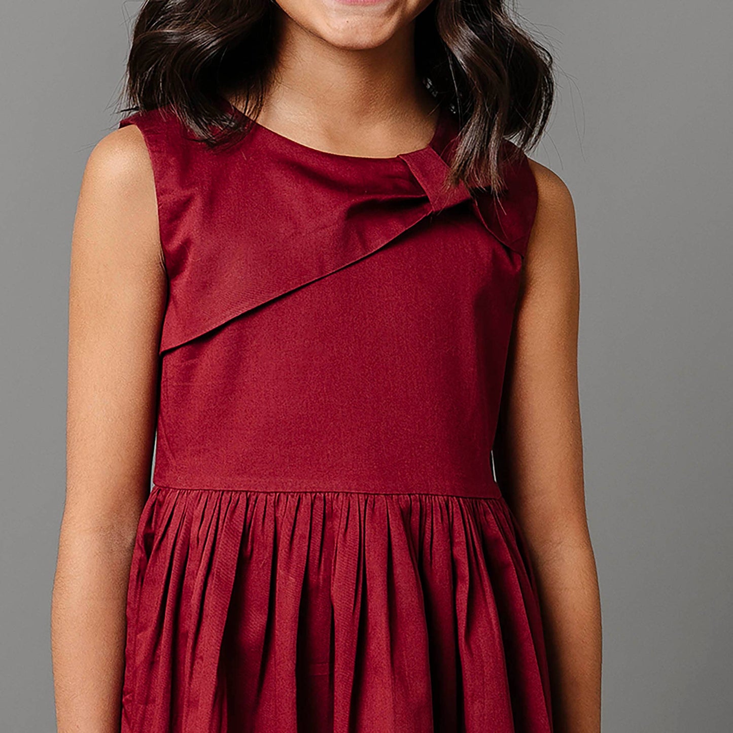 Red dress worn by a person on a gray background