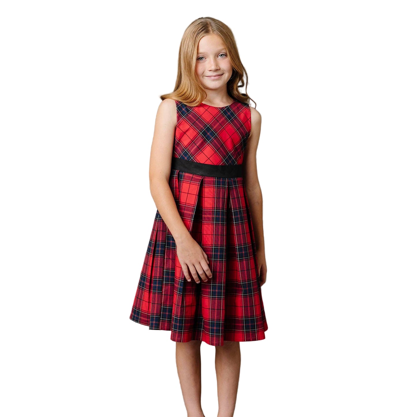 Young girl wearing a red plaid dress with a black belt on a white background