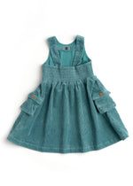 Teal denim pinafore dress on a white background