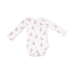 A white long-sleeve baby bodysuit featuring a repeating pattern of light brown cowboy boots and small pink bows, laid flat against a white background.