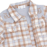 Close-up of a children's plaid button-front shirt with a light blue collar and embroidered details on the shoulders, shown on a white background.