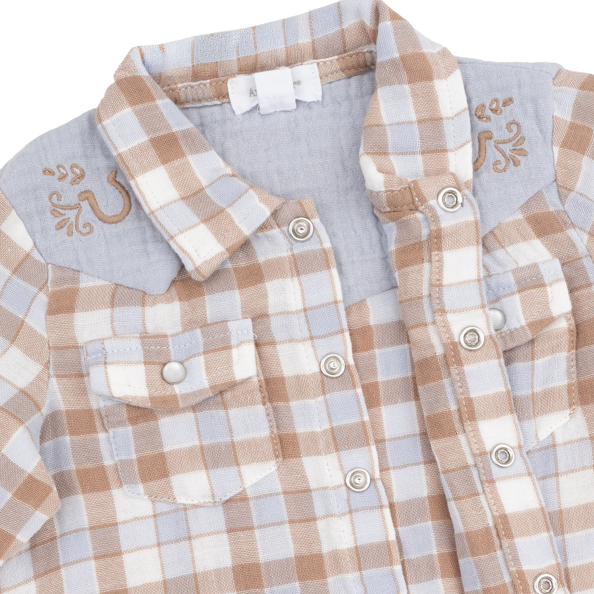 Close-up of a children's plaid button-front shirt with a light blue collar and embroidered details on the shoulders, shown on a white background.
