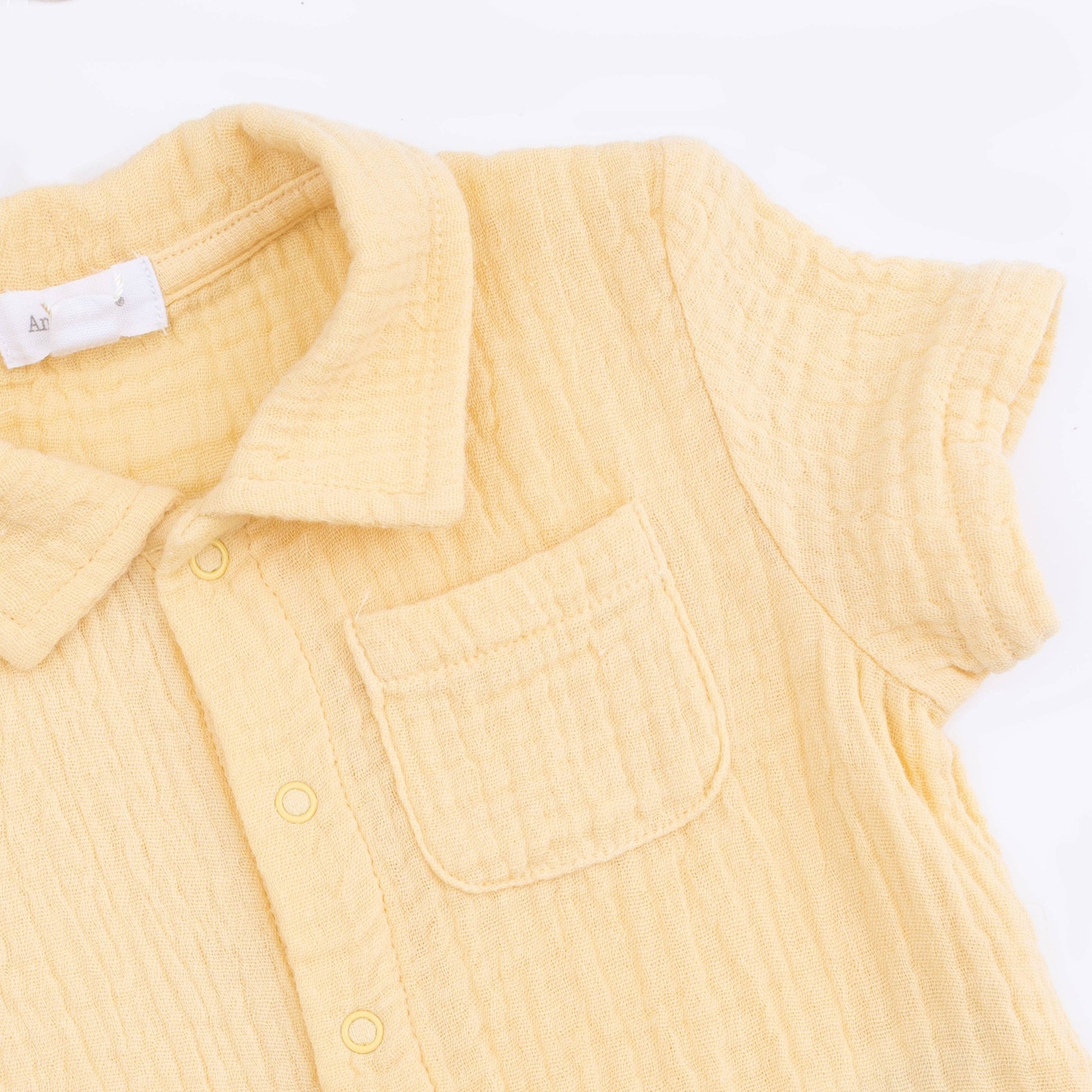 Yellow sleeveless shirt with a collar on a white background