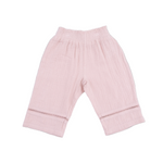 Pink baby pants with a subtle pattern on a white background