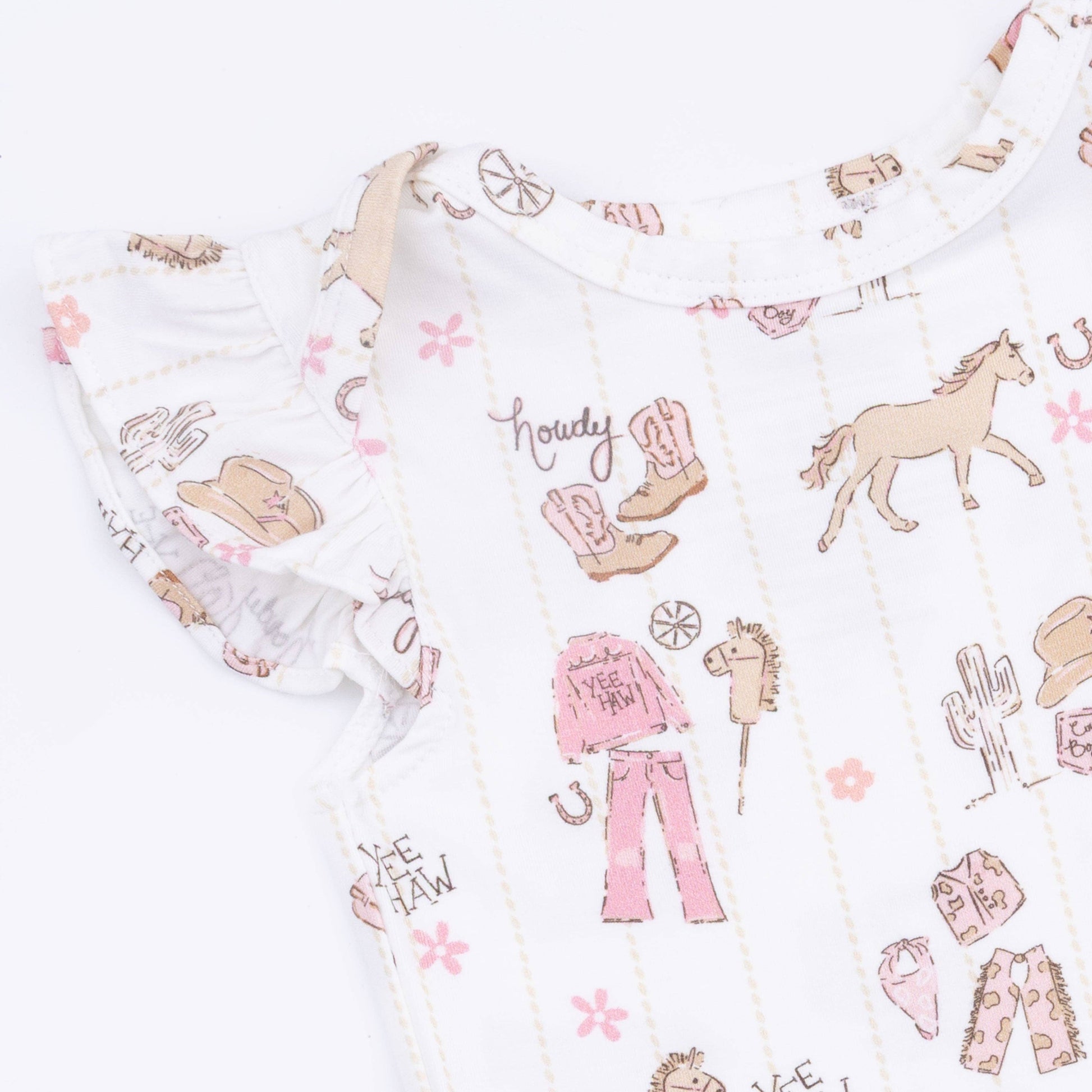 Patterned fabric with cowboy and horse designs on a white background