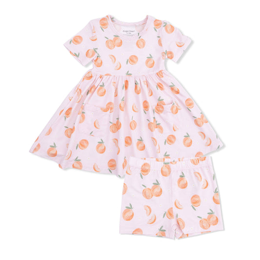Pink dress with peach print on a white background