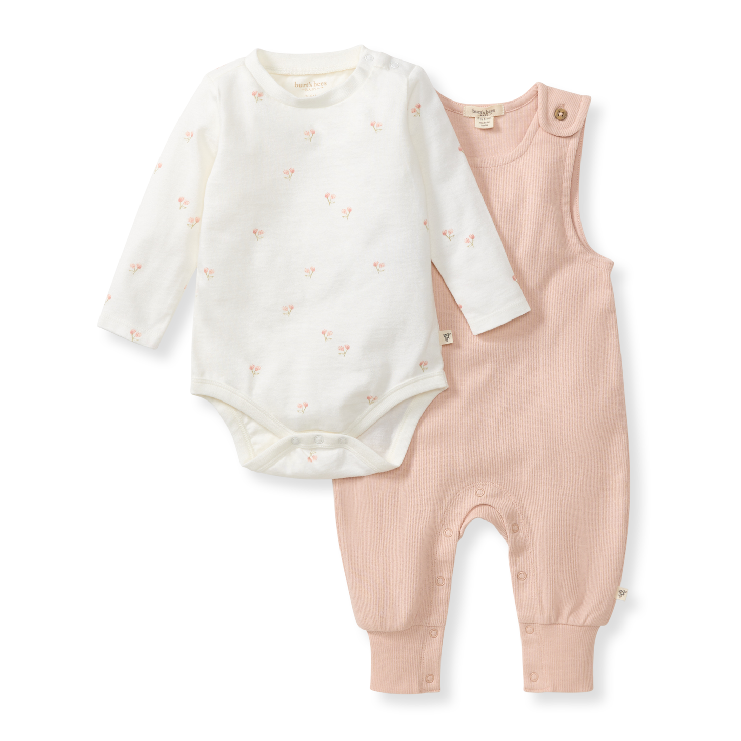 Baby outfit set with white long-sleeve onesie and pink overalls on a white background