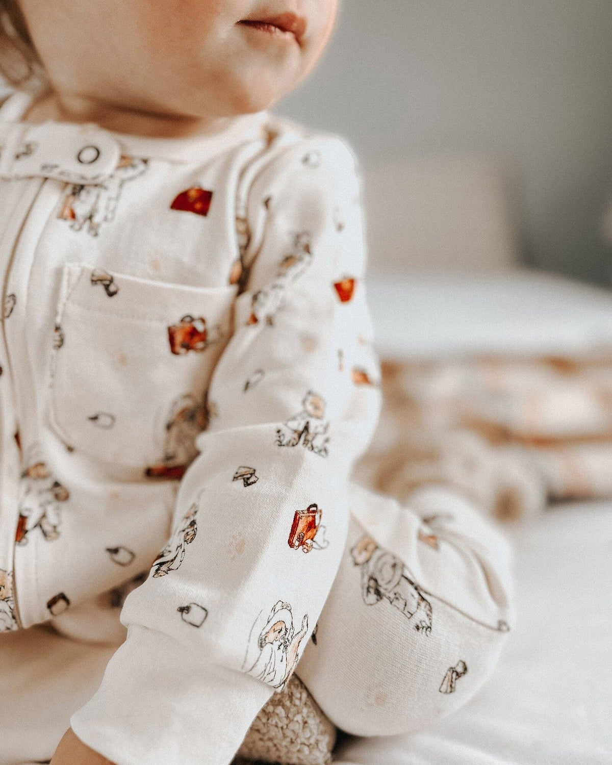 Baby wearing a Paddington bear outfit in a soft-focus setting