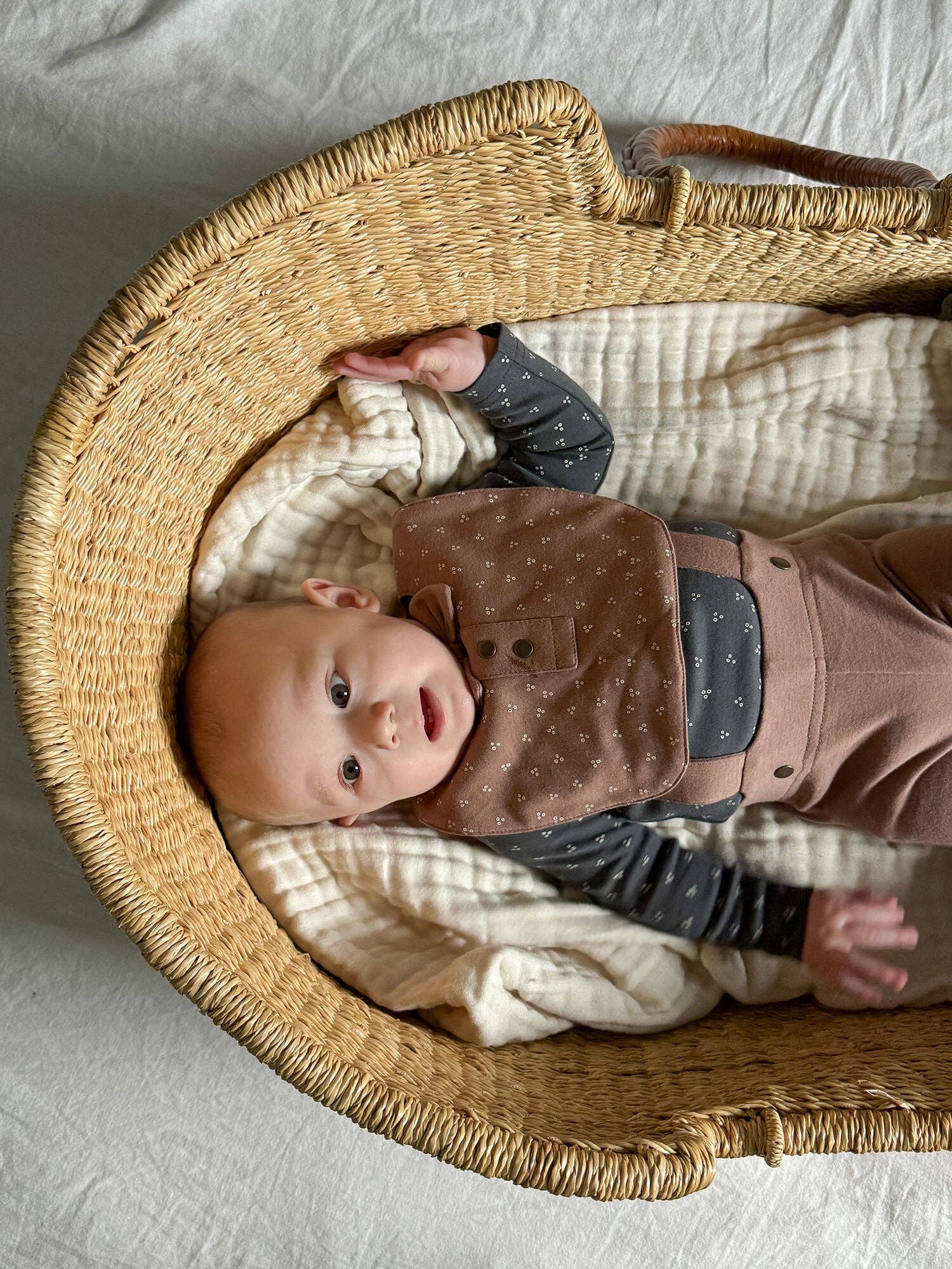 Baby wearing brown bib close-up