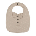 Beige baby bib with bow tie and button details on a white background