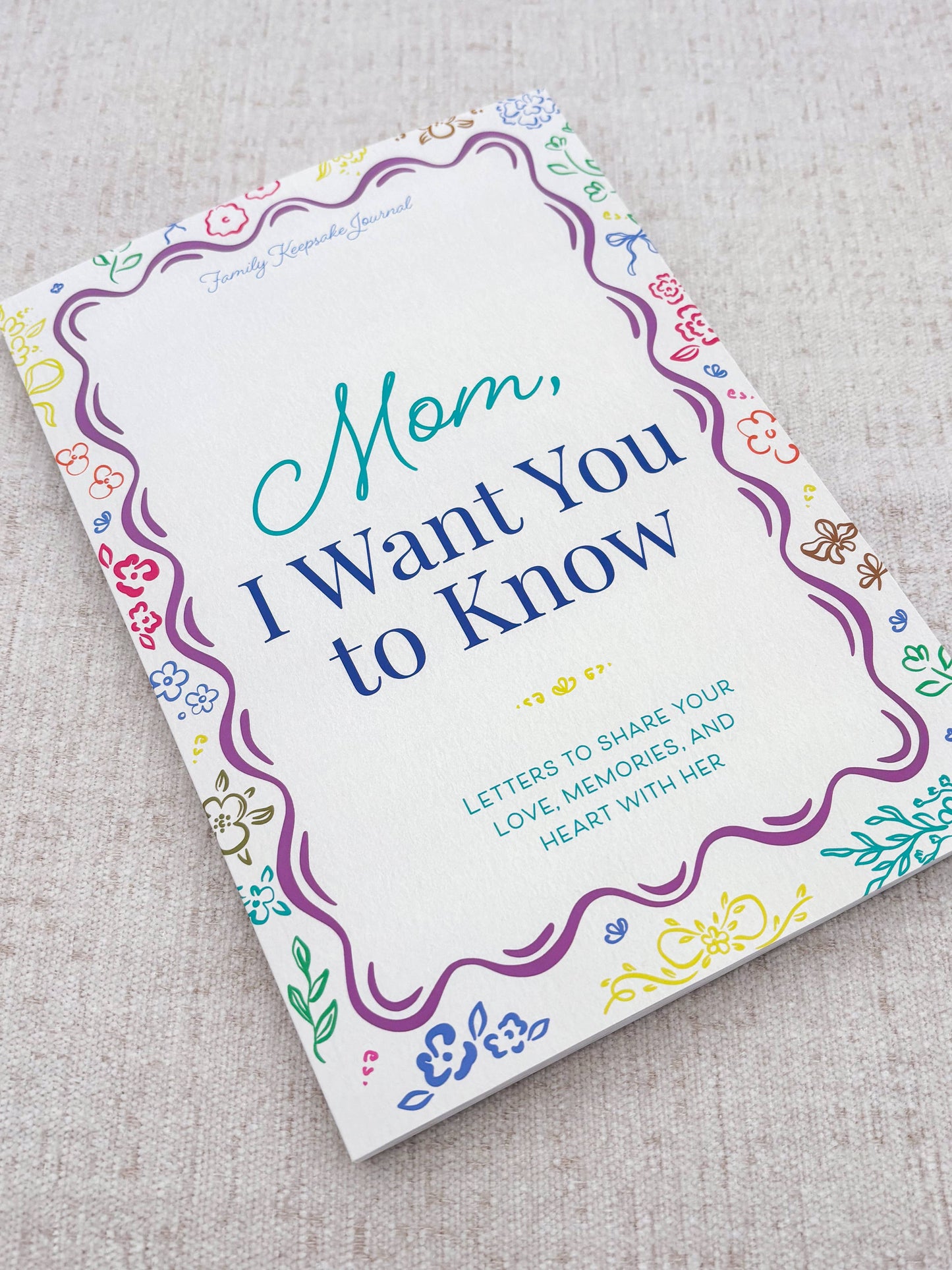 Book titled 'Mom, I Want You to Know' on a textured surface