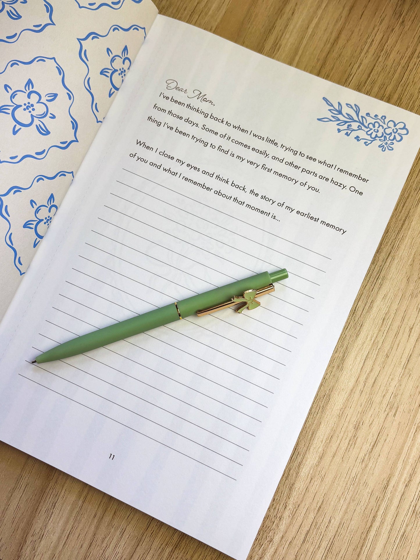 Journal with lined pages and a green pen on a wooden surface