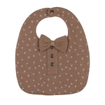 Brown bib with bow and button details on a white background