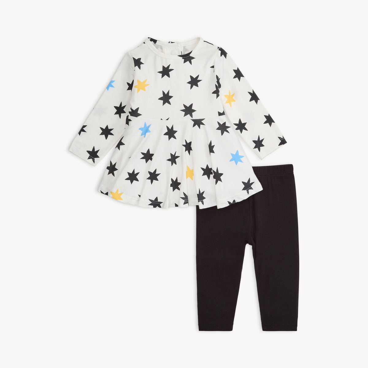 Children's outfit with star-patterned top and black pants on a white background