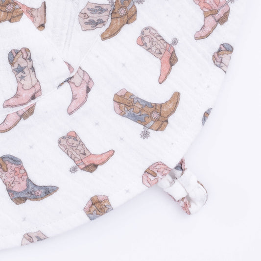 Pattern of pink and blue cowboy boots on a white background
