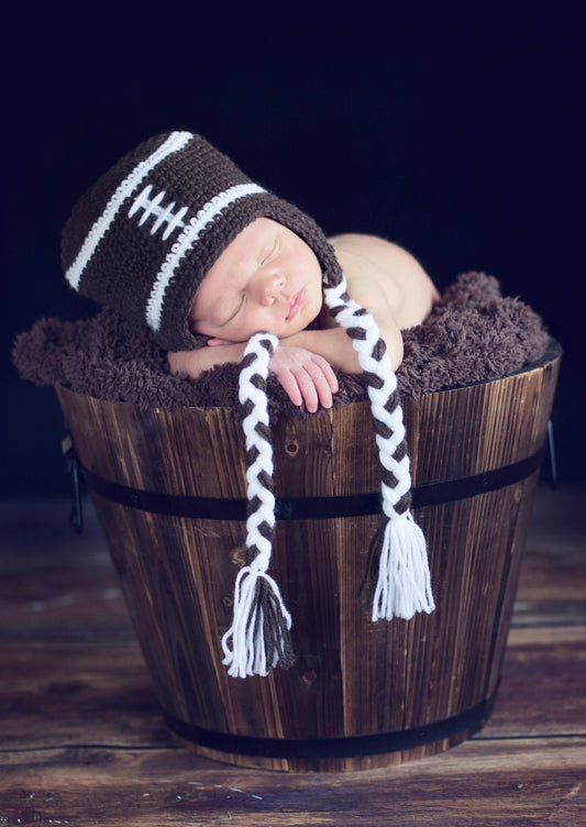 newborn baby photo with football hat