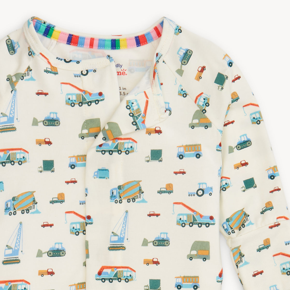 Infant coverall with truck pattern on a white background