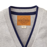 Gray sweater with navy trim and a visible brand label on a white background