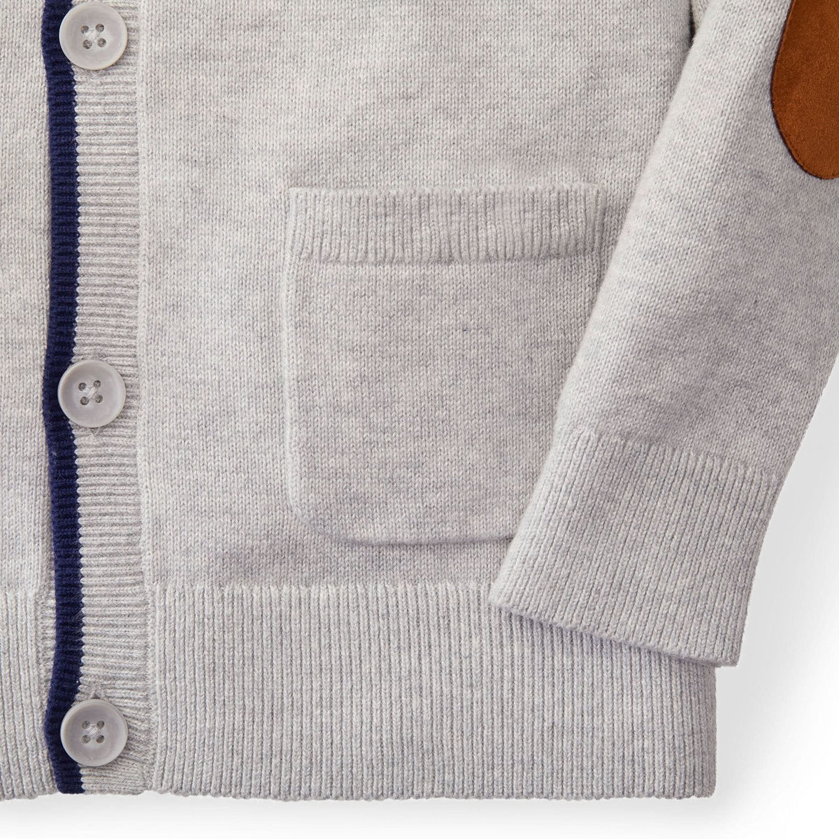 Close-up of a gray cardigan with button details on a white background