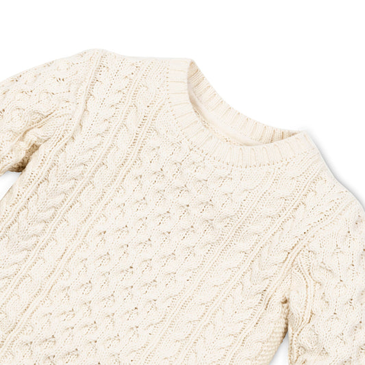 Close-up of crew neck and cable knit stitch on boys’ ivory fisherman sweater