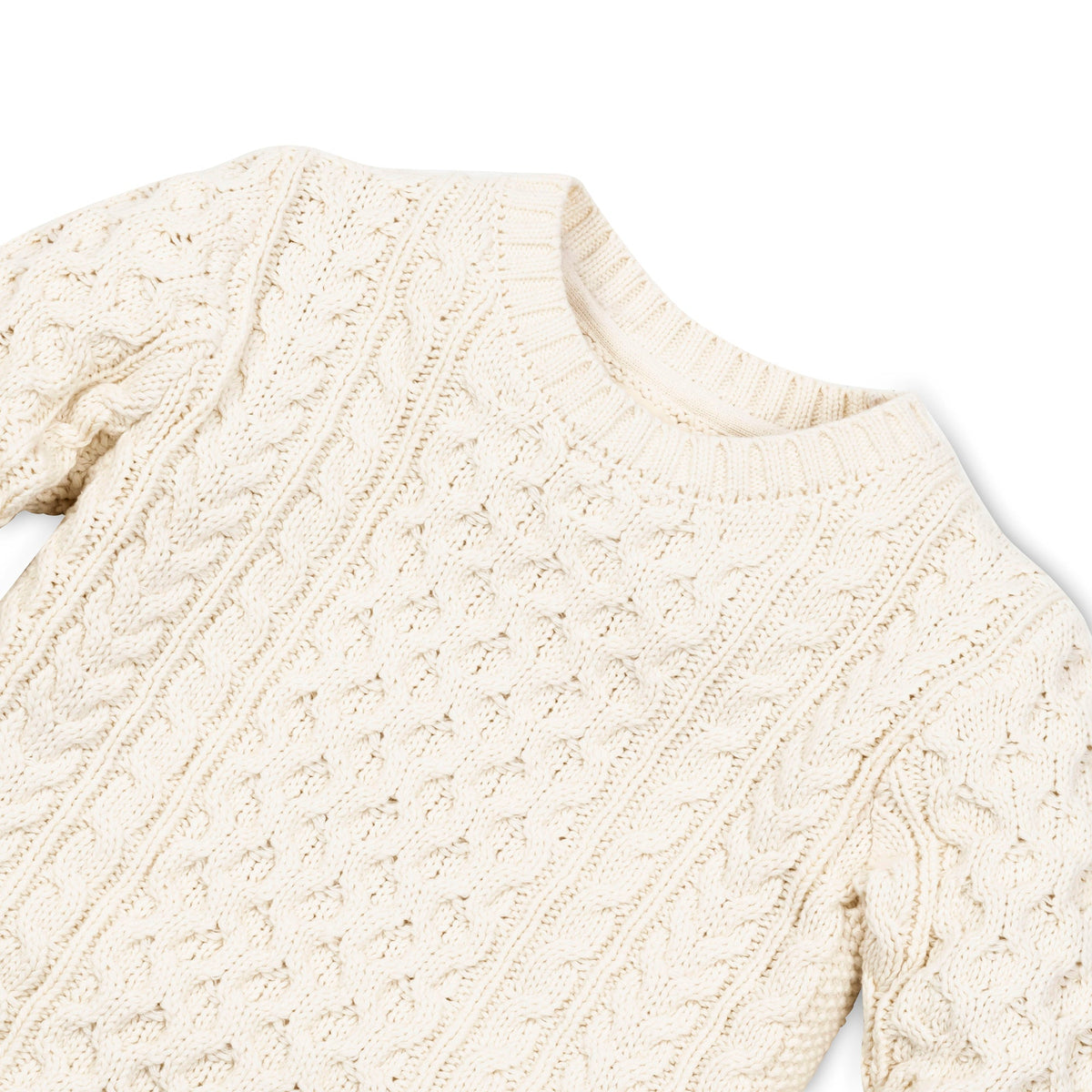 Close-up of crew neck and cable knit stitch on boys’ ivory fisherman sweater