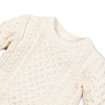 Close-up of crew neck and cable knit stitch on boys’ ivory fisherman sweater