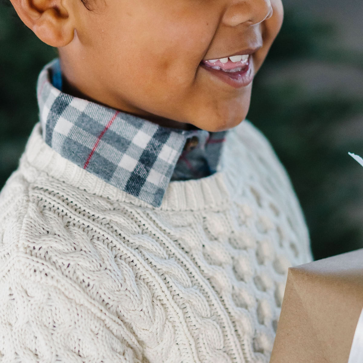 Close-up of boy wearing ivory organic cotton fisherman sweater