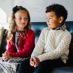 Boy wearing ivory cable knit fisherman sweater