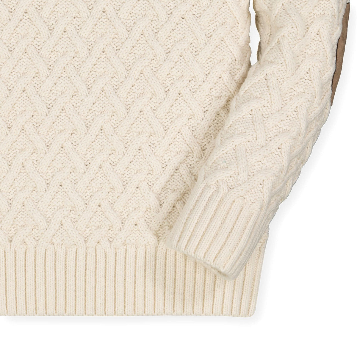 Close-up of a cream-colored cable knit sweater on a white background